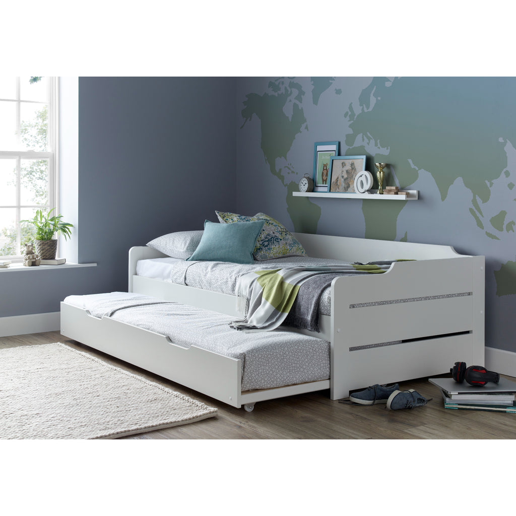Copella Pine Guest Bed With Trundle with trundle partially extended in a furnished room