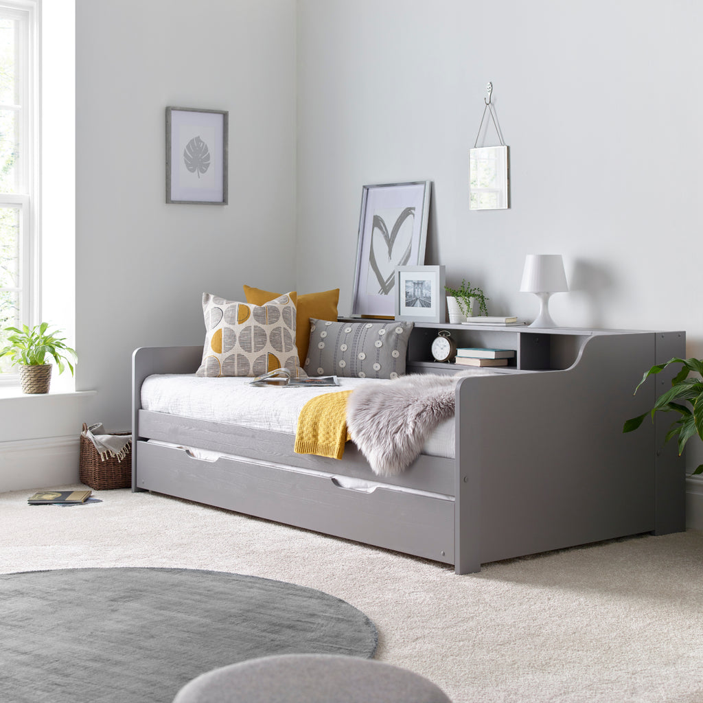 Tyler Pine Guest Bed With Trundle in grey. Shown in furnished room with trundle closed.