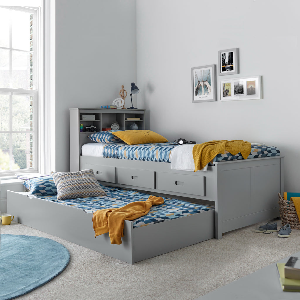 Veera Guest Bed & Trundle in grey in furnished room, trundle open and made up as a second bed