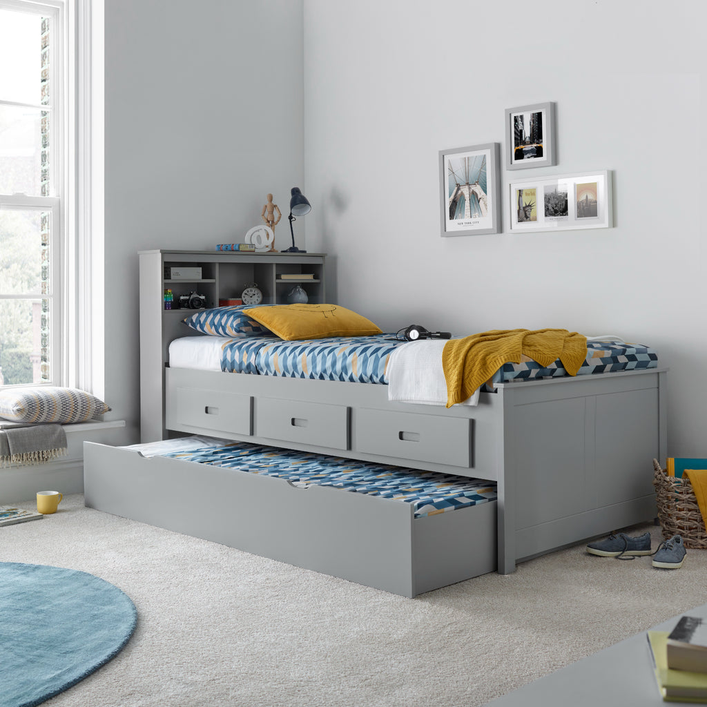 Veera Guest Bed & Trundle in grey in furnished room, trundle open and made up as a second bed and partially closed