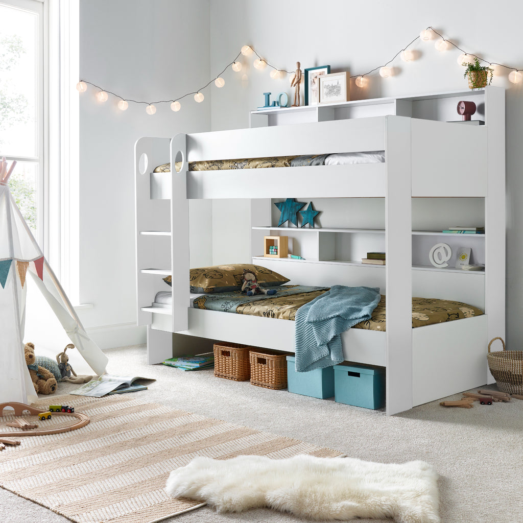 Oilver Solid Wood Bunk Bed in white in furnished room, underbed area used for storage